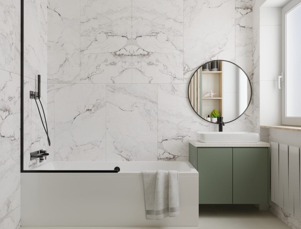 Contemporary bathroom with round mirror and green vanity – Intervibe Studio