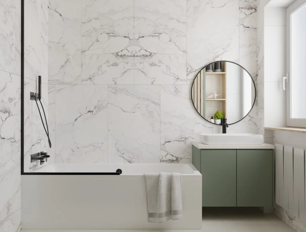 Contemporary bathroom with round mirror and green vanity – Intervibe Studio