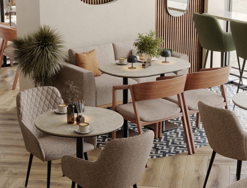 Café seating area with round marble tables, wooden chairs, and soft beige armchairs