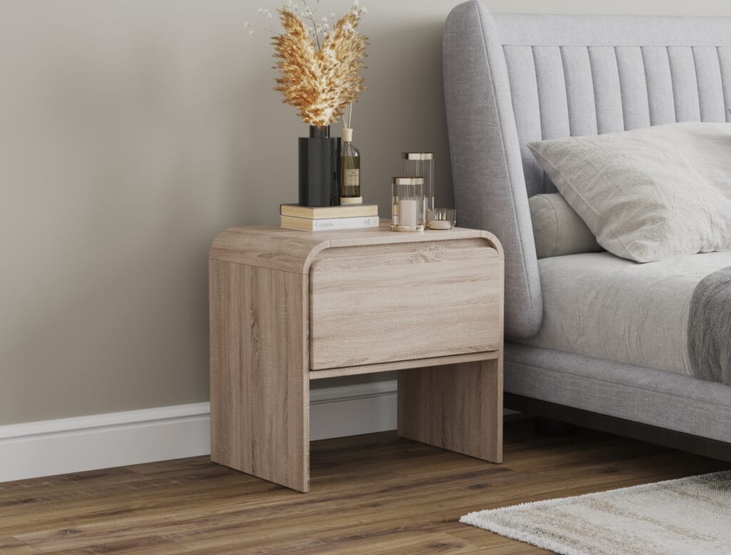 Oak bedside table placed next to bed.