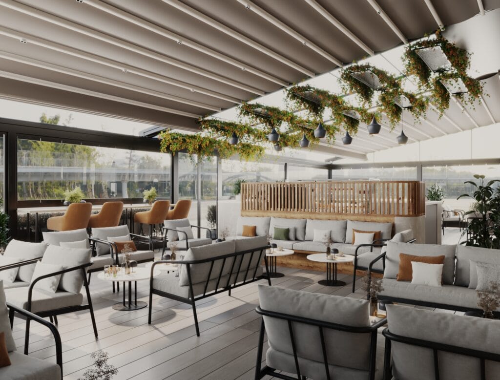 Panoramic view of café terrace with glass enclosure, modern tables, and lounge seating