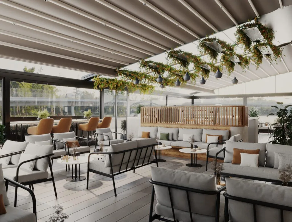 Panoramic view of café terrace with glass enclosure, modern tables, and lounge seating