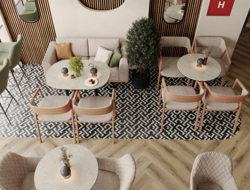 Top view of café seating with sofas, round tables, and patterned floor tiles