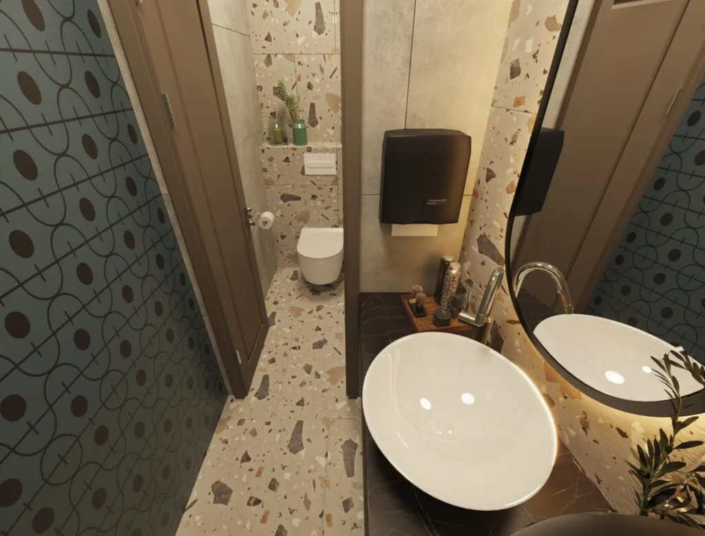 Top view of men’s restroom with terrazzo walls, sink basin, and toilet