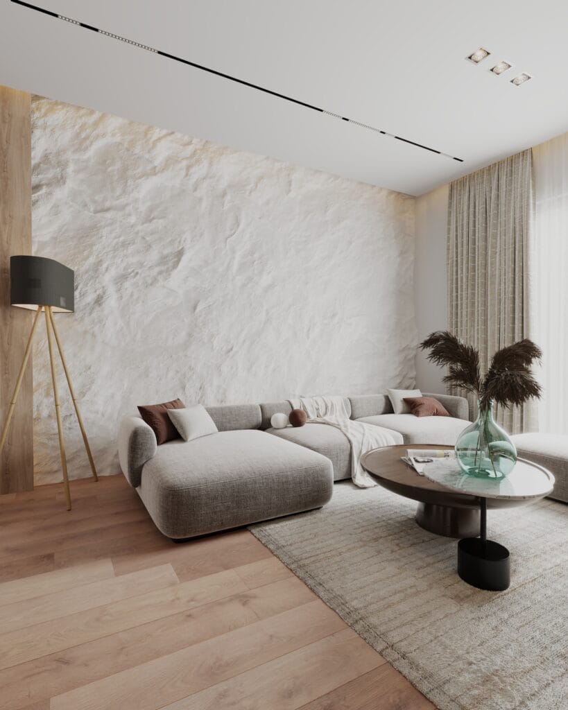 Contemporary living room design with a curved sofa, textured wall and soft neutral materials