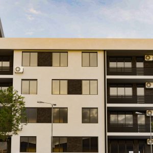 Modern mixed-use residential and commercial building with light and dark facade